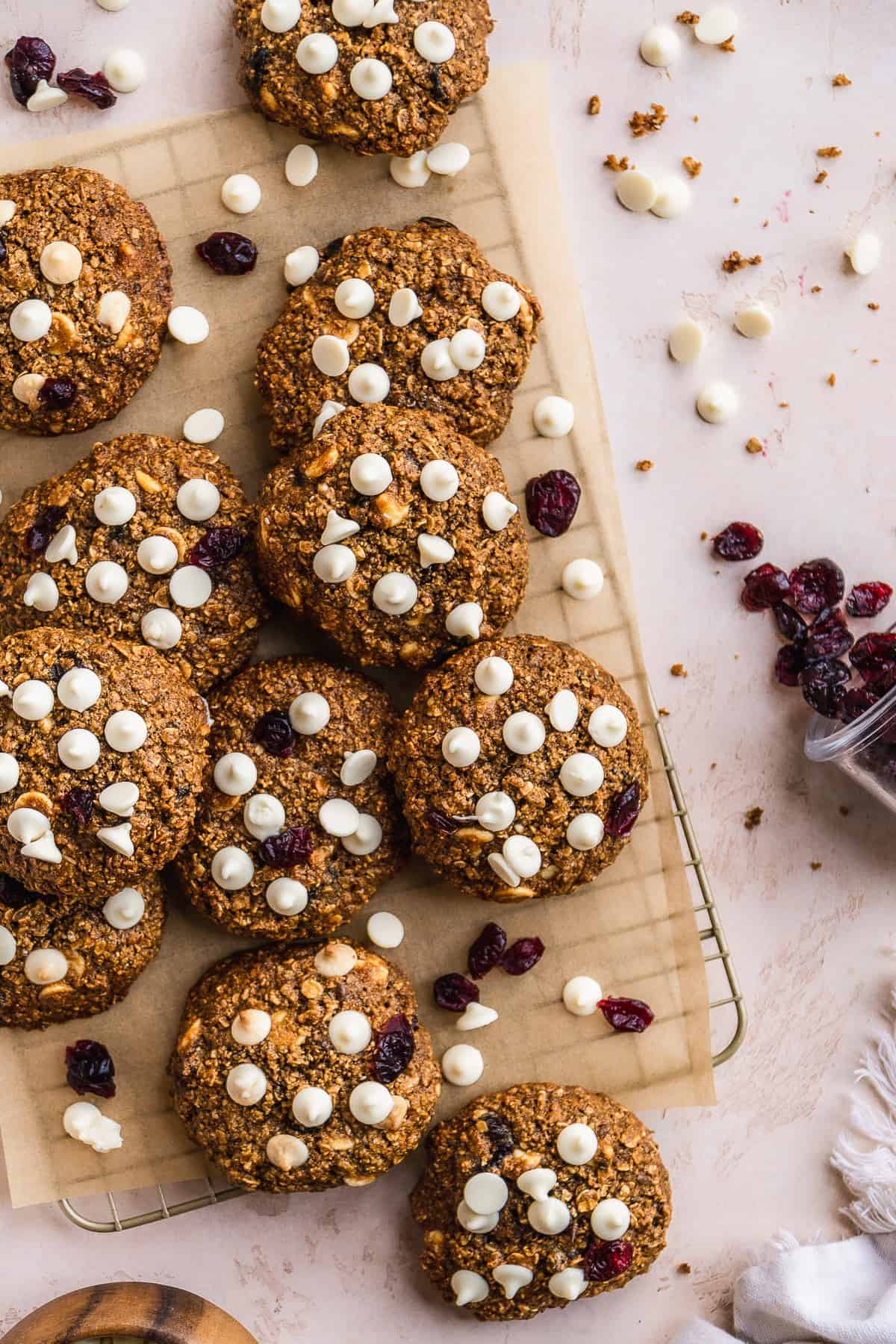 White chocolate oatmeal cookies scattered on a cookie rack.