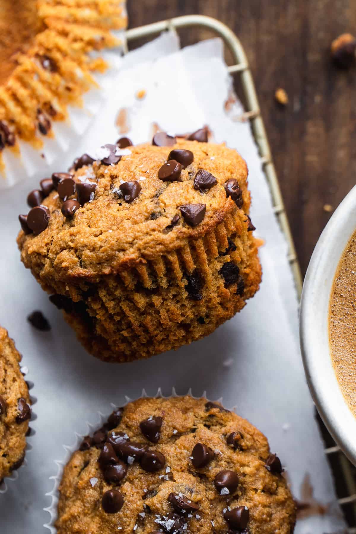 Chocolate chip paleo muffins laying on a wire rack.