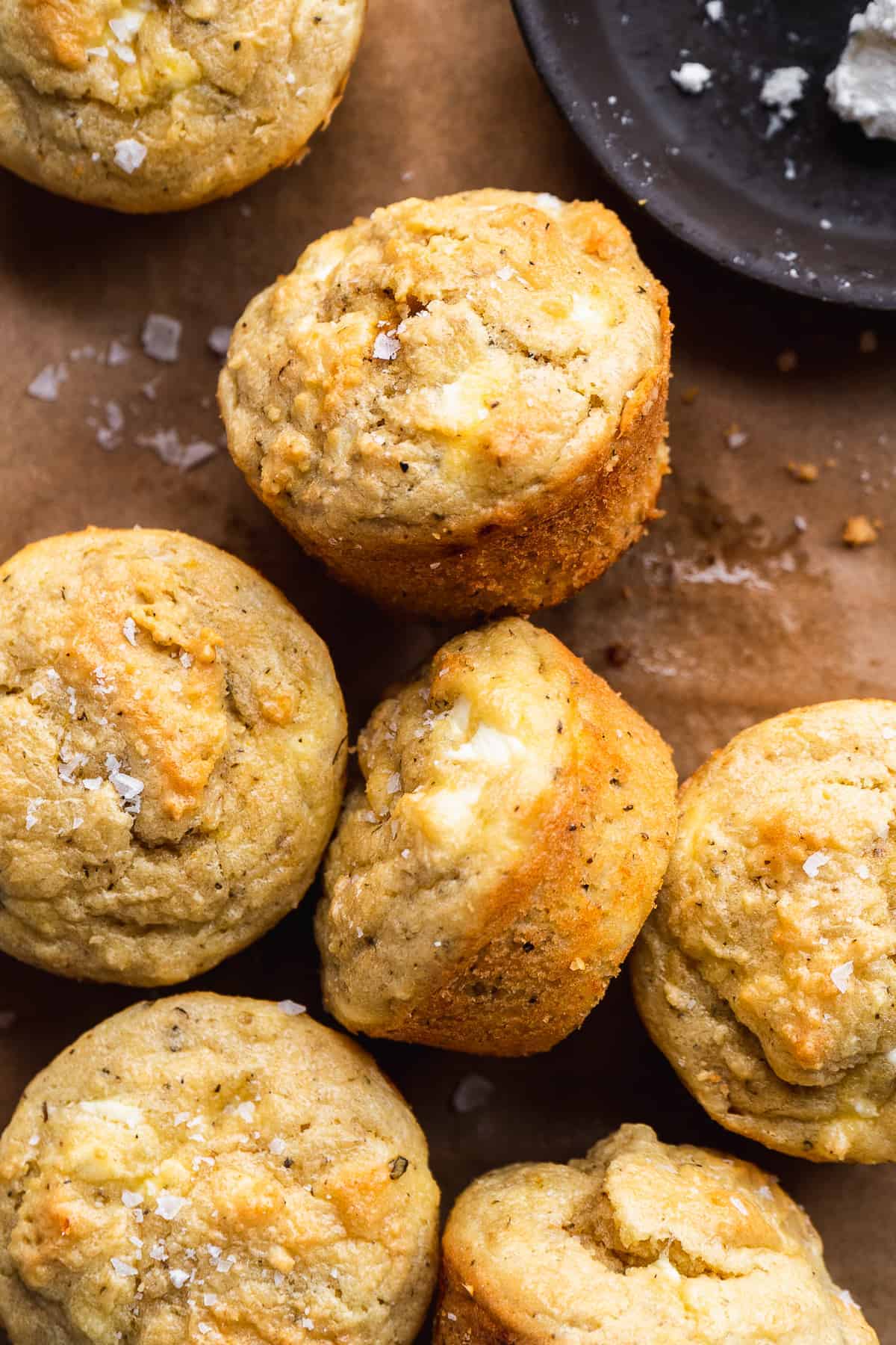 Goat cheese muffins scattered on parchment paper.