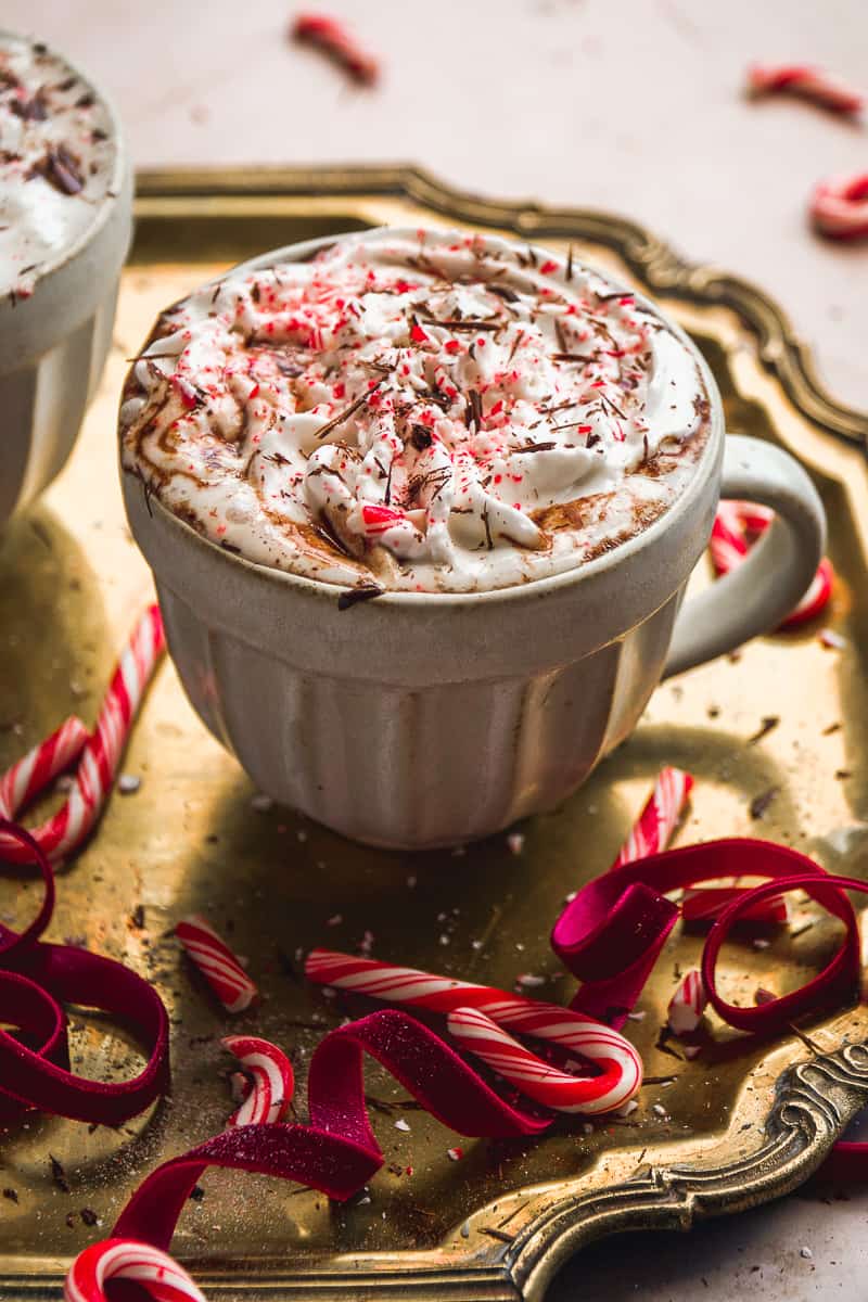 Skinny peppermint mocha in a coffee cup with peppermint on top.
