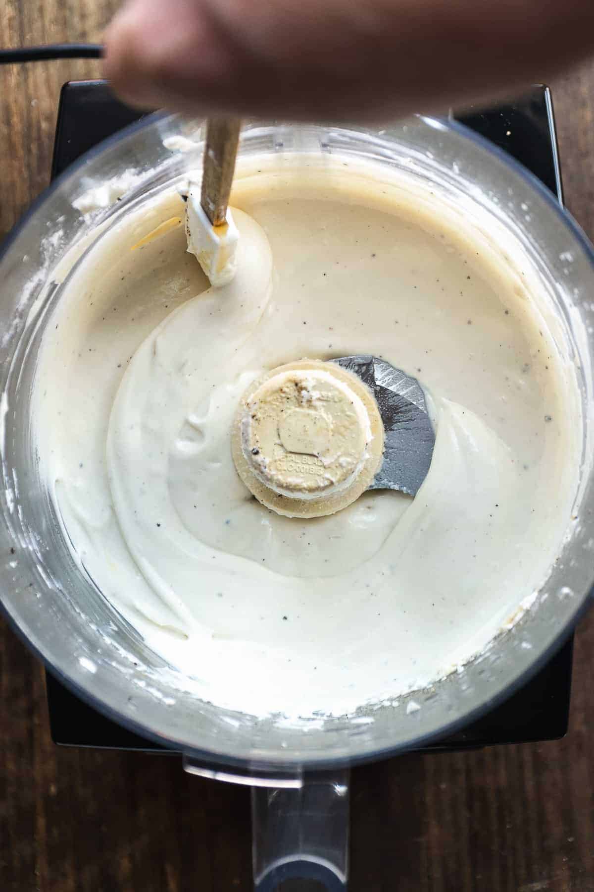 Overhead view of whipped goat cheese dip in a food processor.