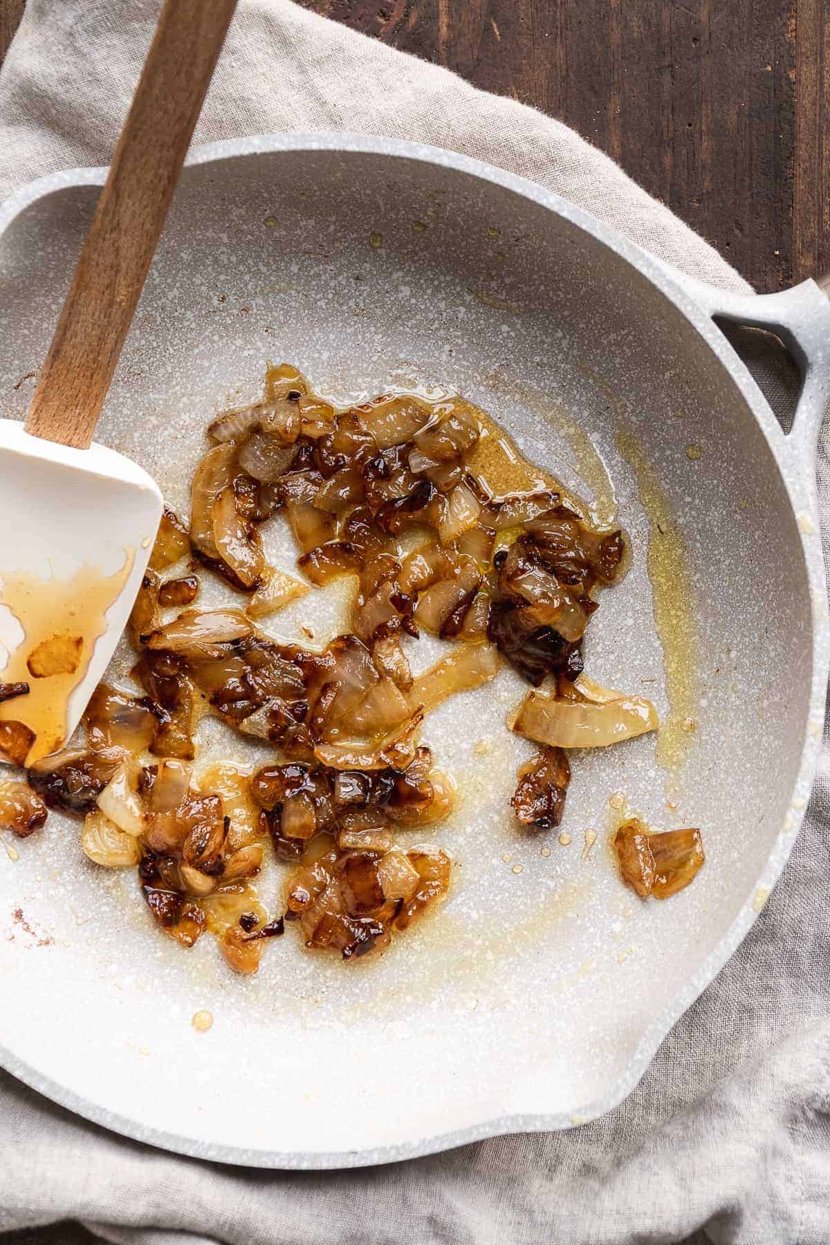 A gray skillet with caramelized onions.