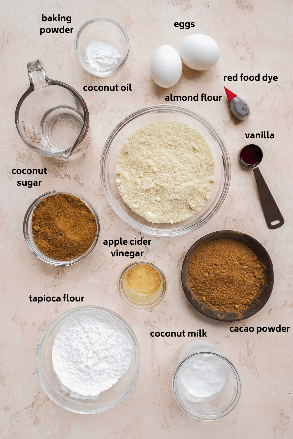 Gluten free red velvet cupcake ingredients on a pink surface.