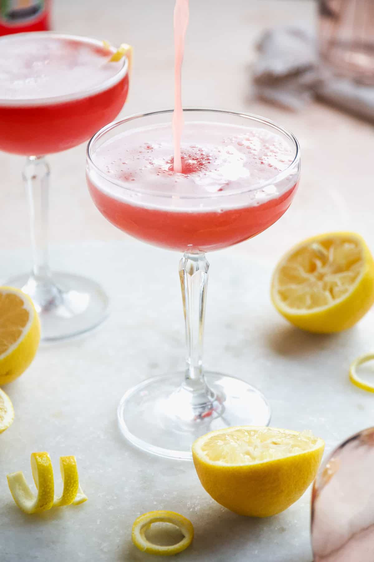 Aperol gin cocktail being poured into a glass.