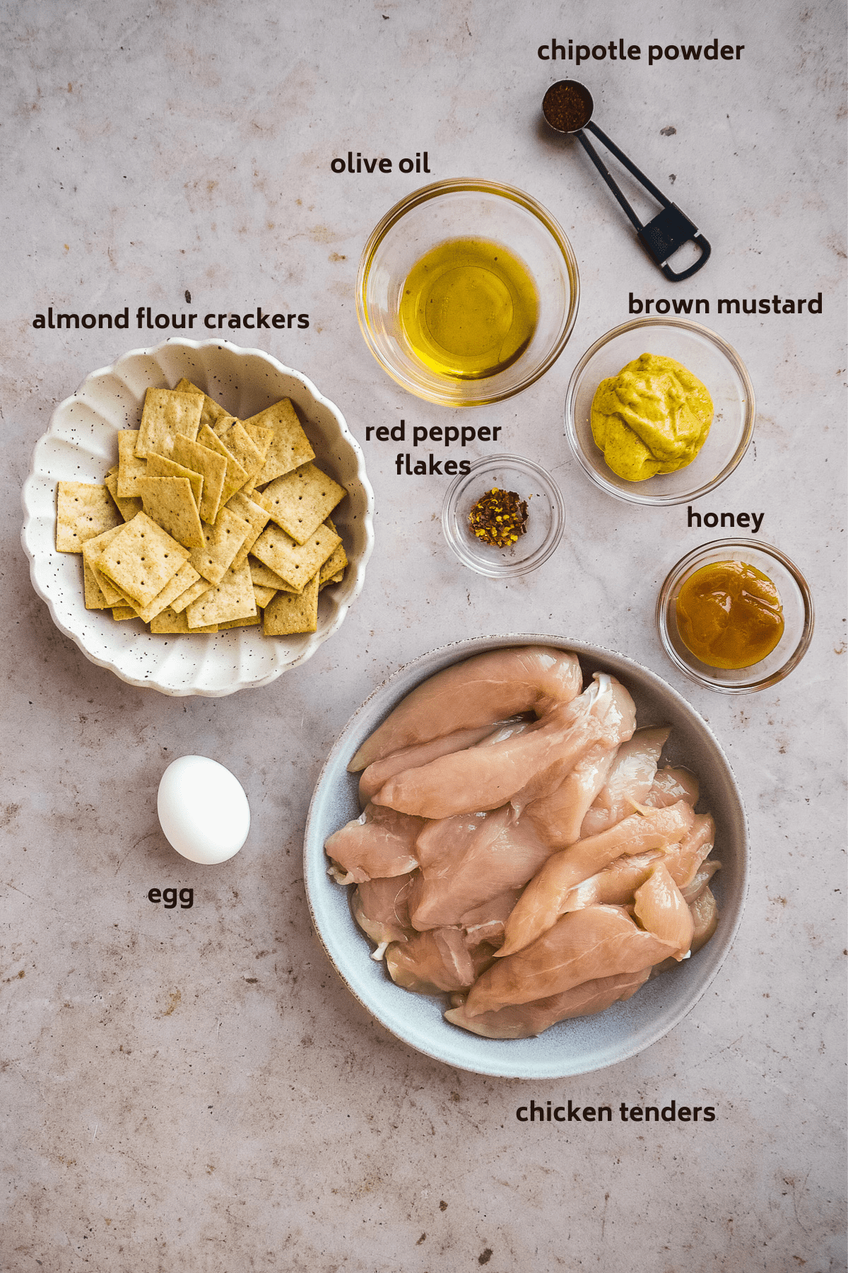 Chicken tender ingredients on a gray surface.