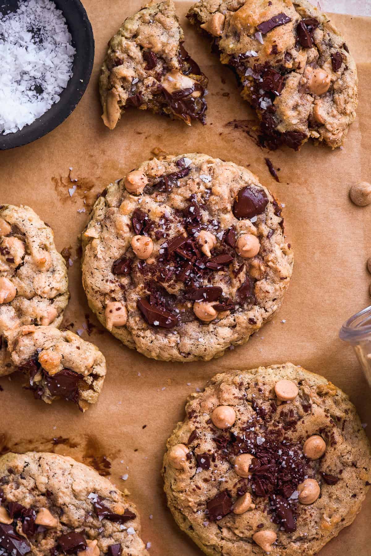 Peanut butter chip cookies scattered on parchment paper.