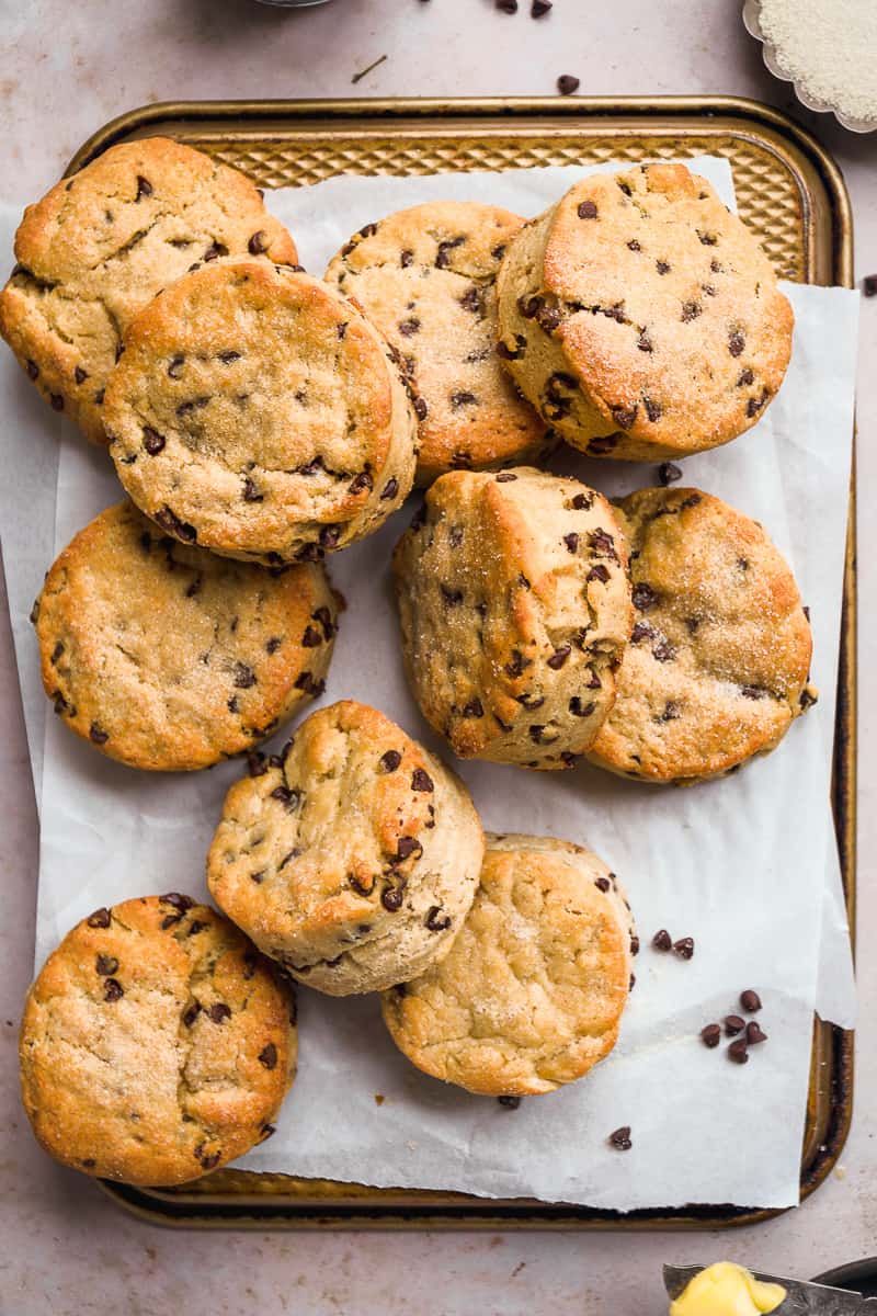 Chocolate chip biscuits scattered on parchment paper.