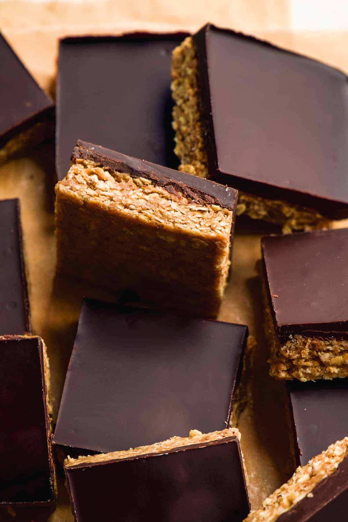 Peanut butter chocolate oat bars scattered on parchment paper.