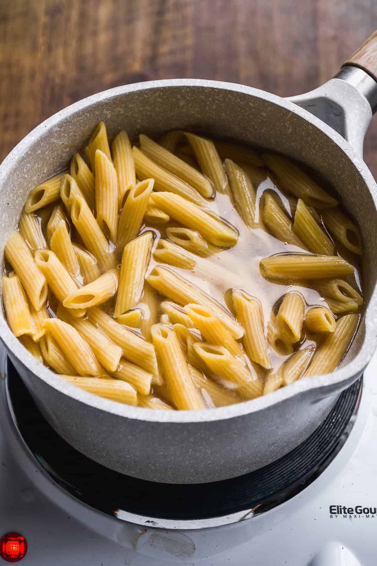 Pot with cooked pasta floating on top.