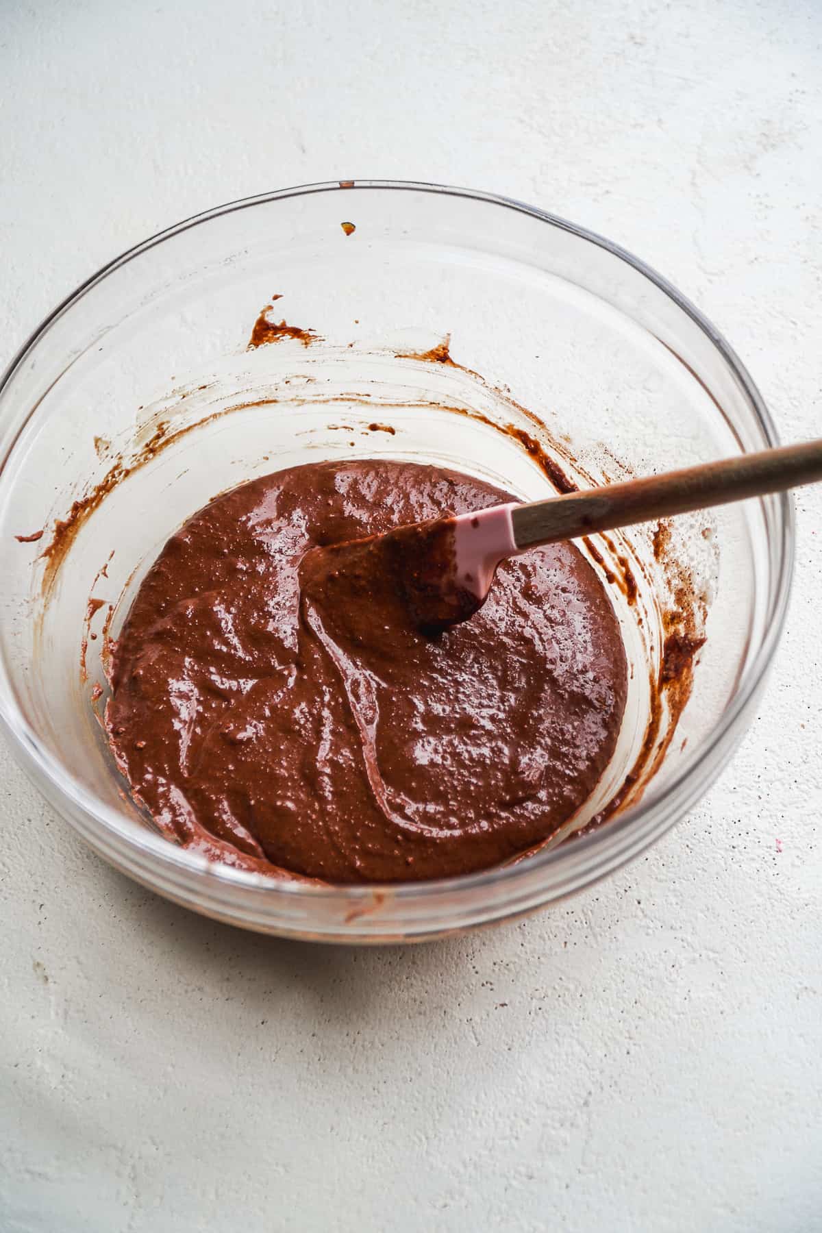 Chocolate cookie batter in a glass bowl.