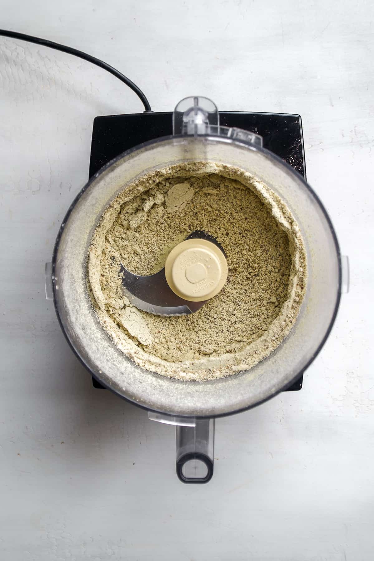 Food processor with dry ingredients blended.
