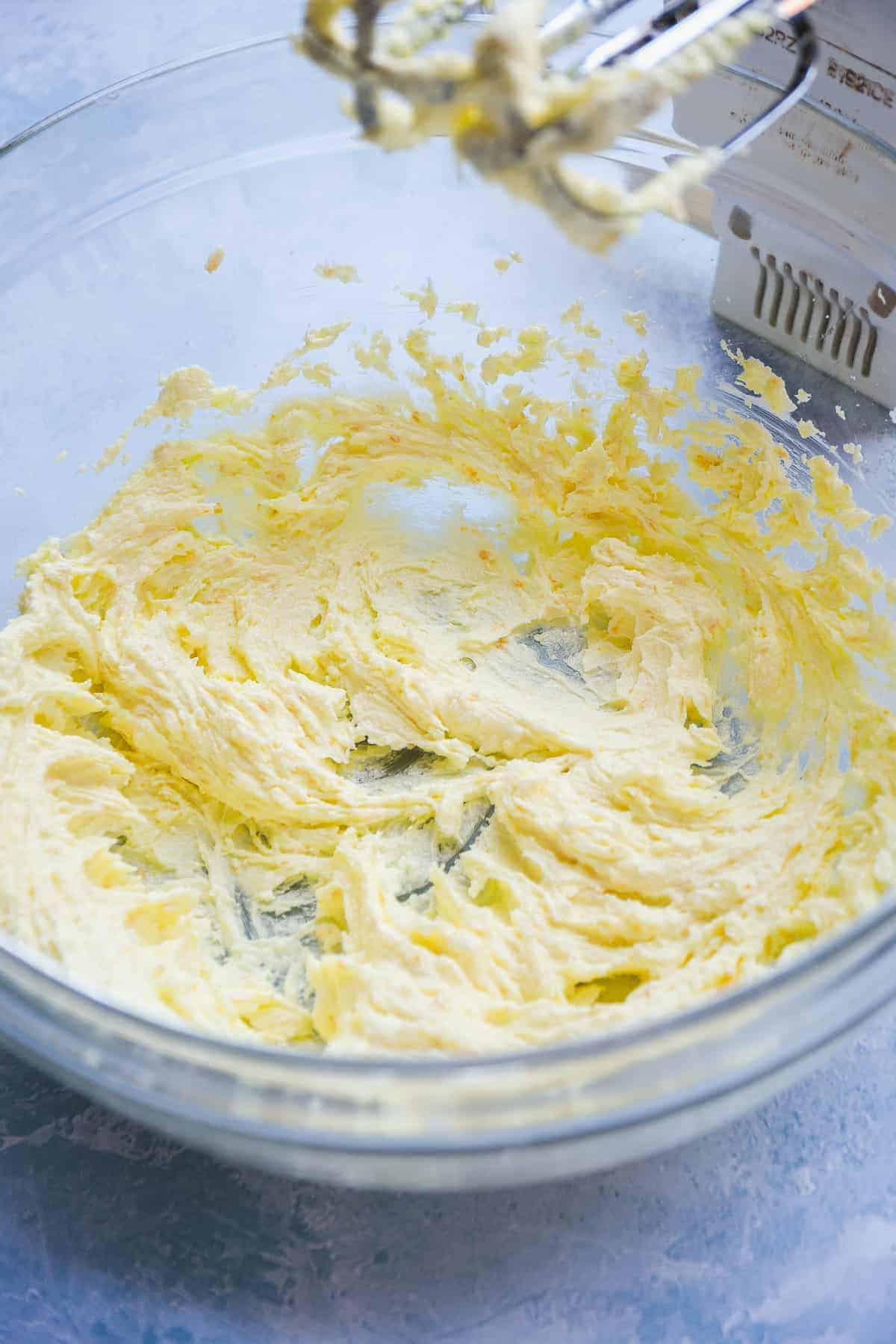 Mixing bowl with butter and sugar beaten together.