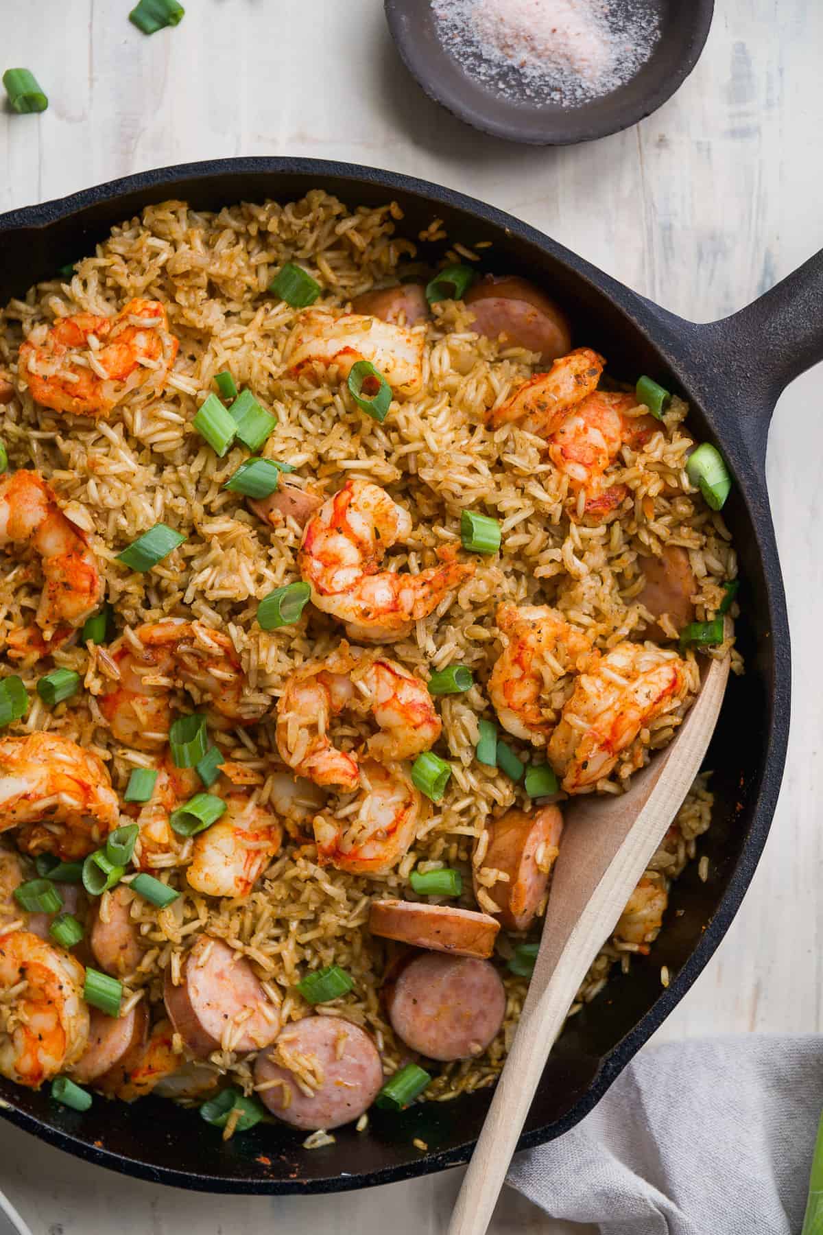 Overhead view of a skillet with rice and cajun shrimp. 