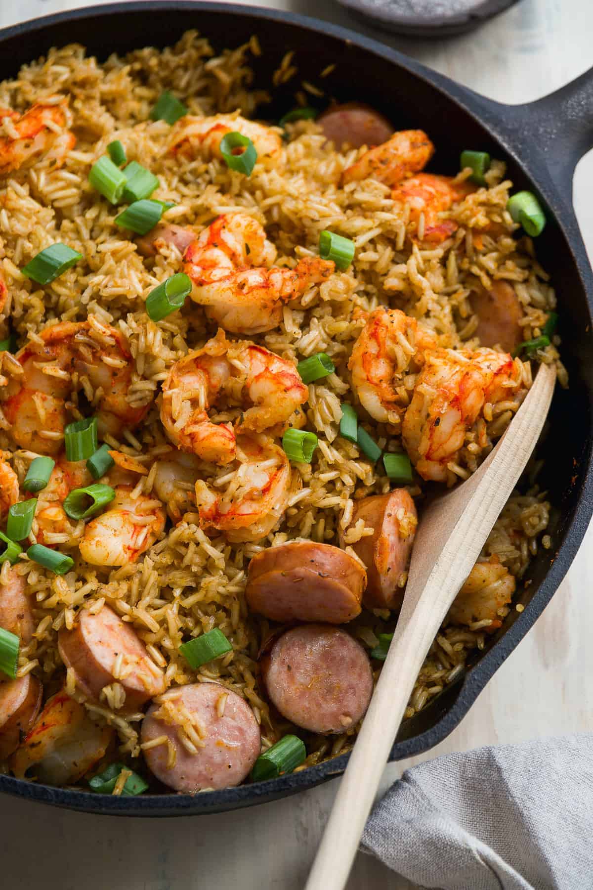 Black skillet with cajun rice and shrimp and kielbasa.