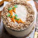 Chocolate carrot cake with carrots pipped on top.