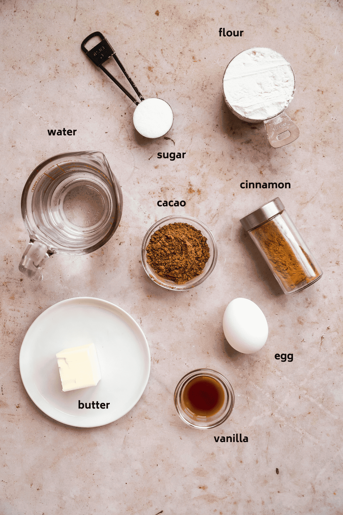 Image of chocolate churro ingredients on a tan surface.