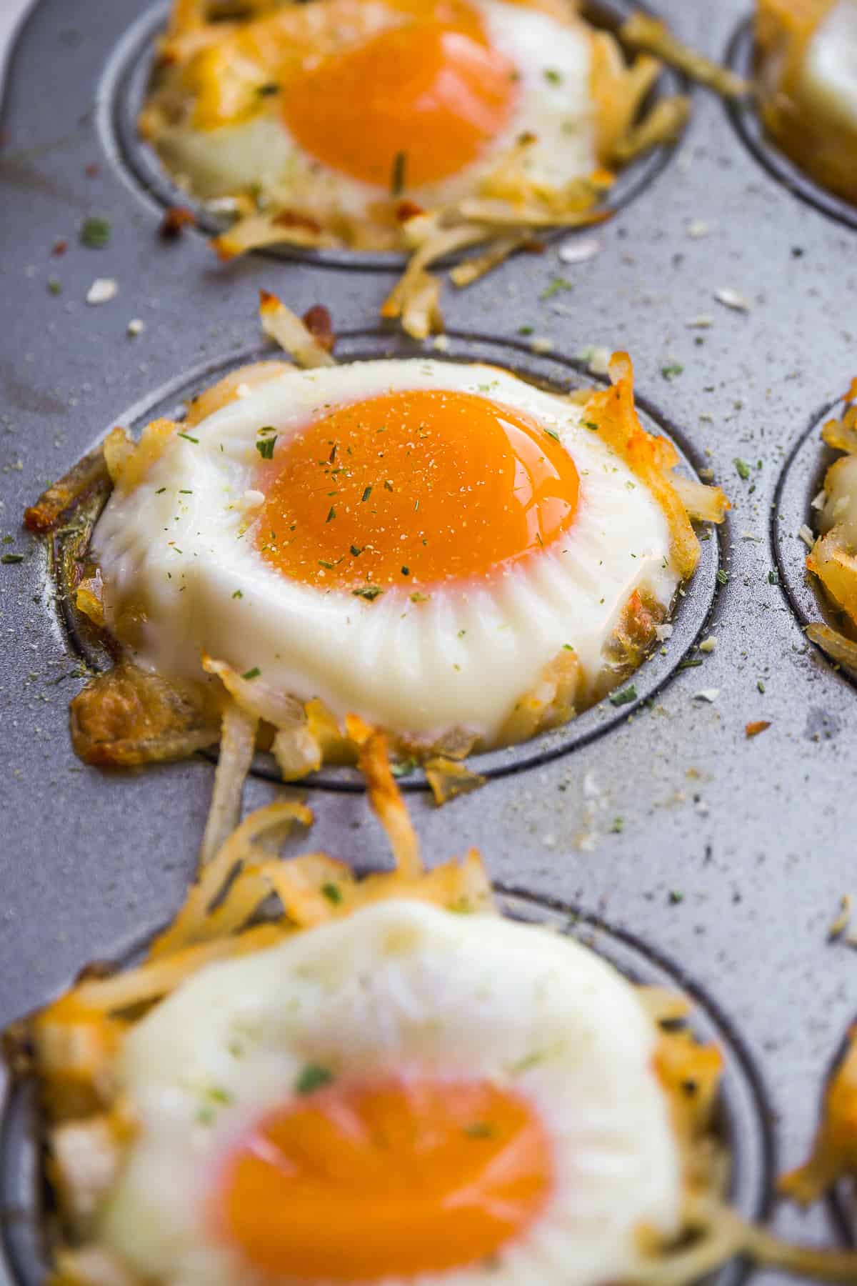 Hash brown egg cups baked in a pan.
