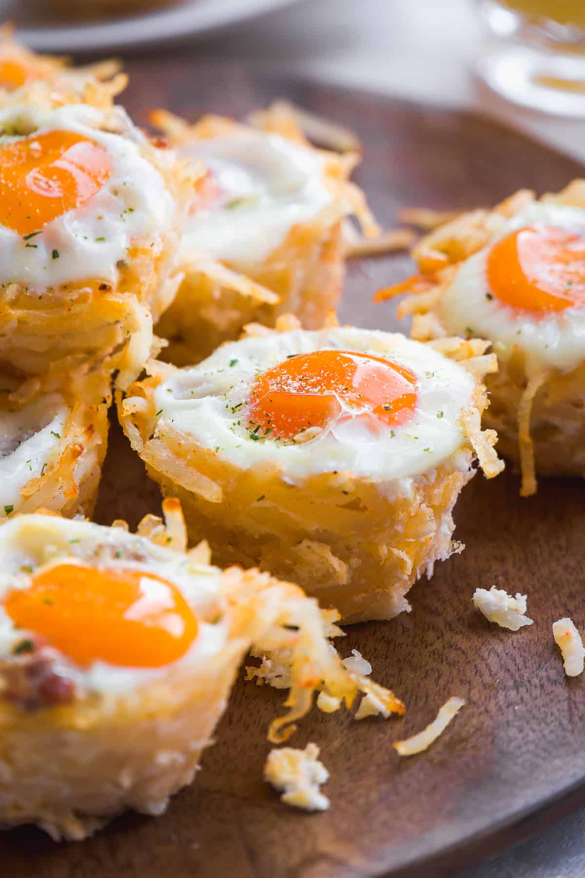 Hash brown egg cups on a wooden platter.