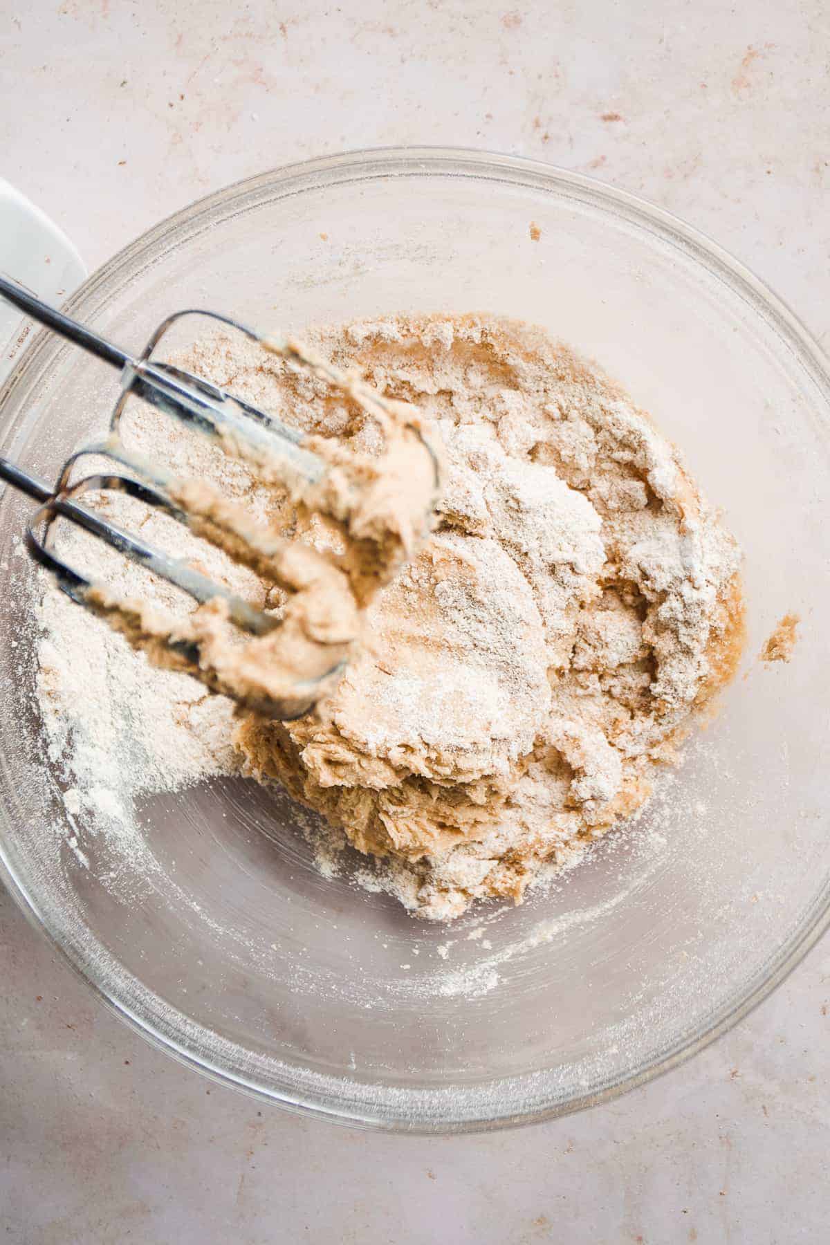 Overhead view of a mixing bowl about to mix in flour.