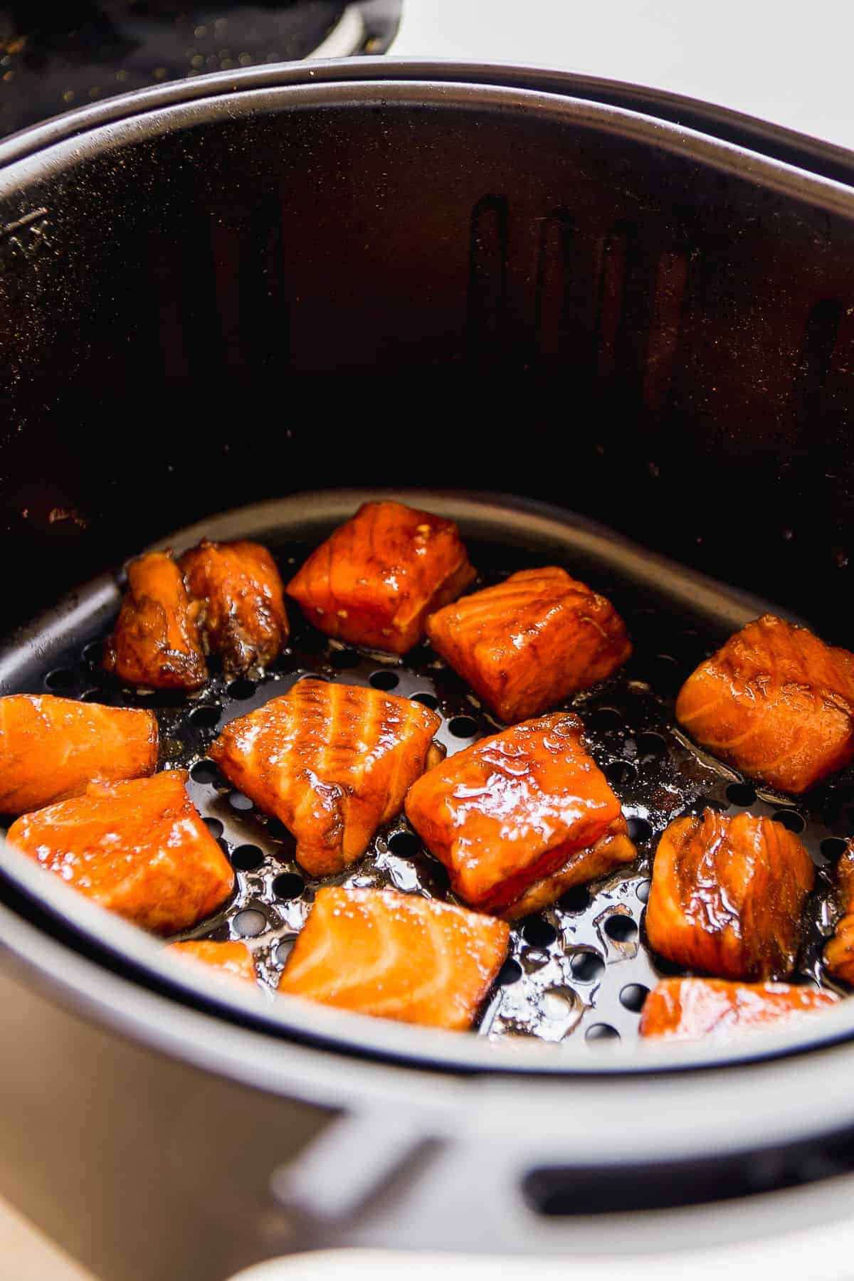 Salmon chunks about to be cooked in an air fryer.