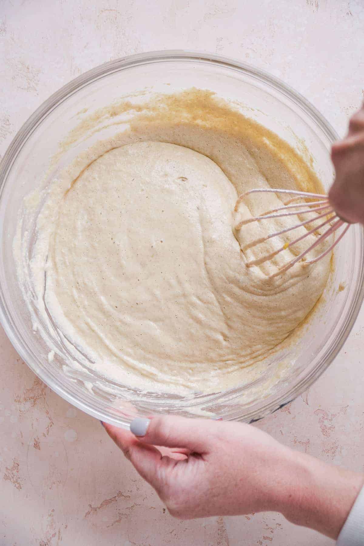 Pancake batter being mixed with a whisk.