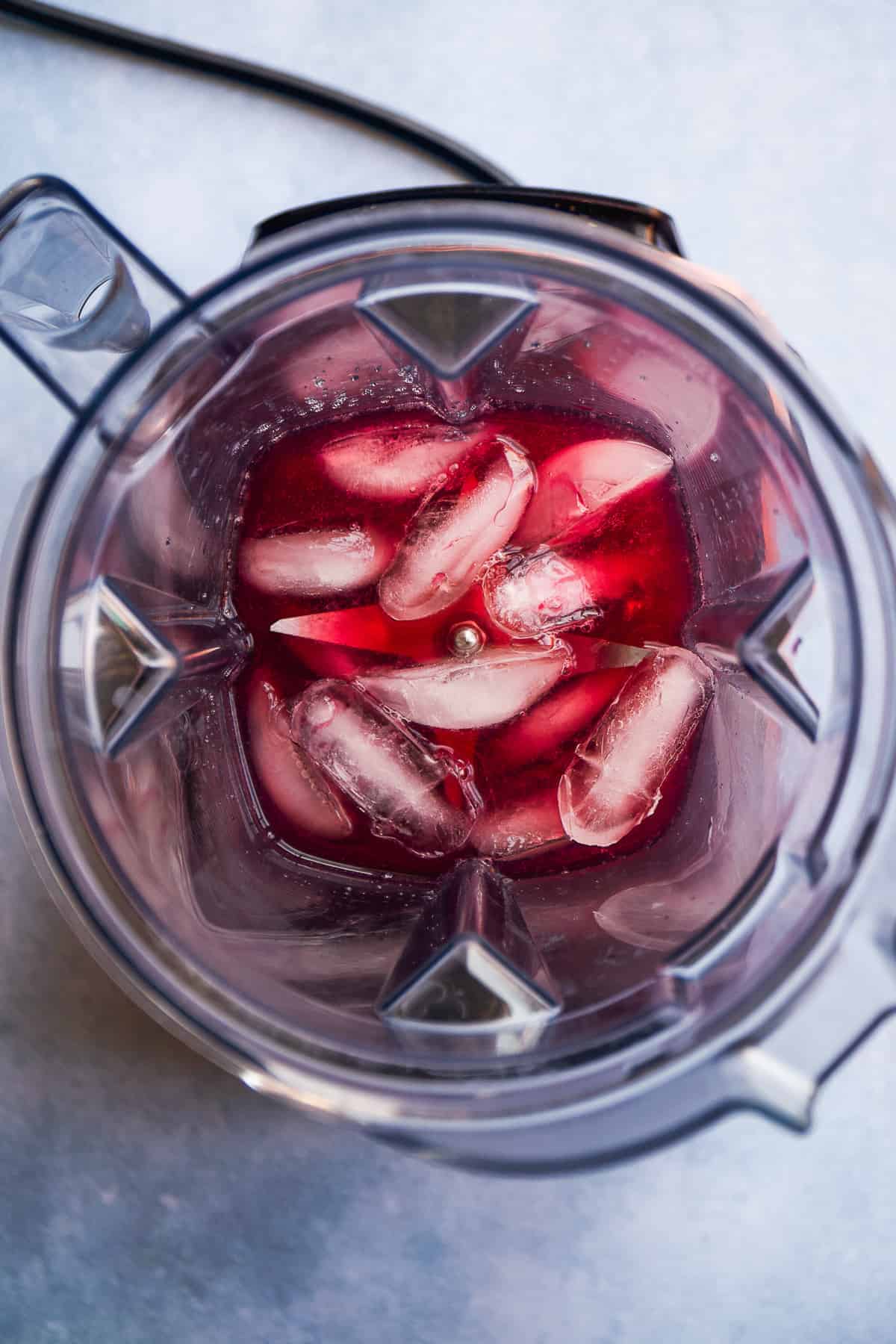 Overhead view of pomegranate mocktail margarita in a blender.