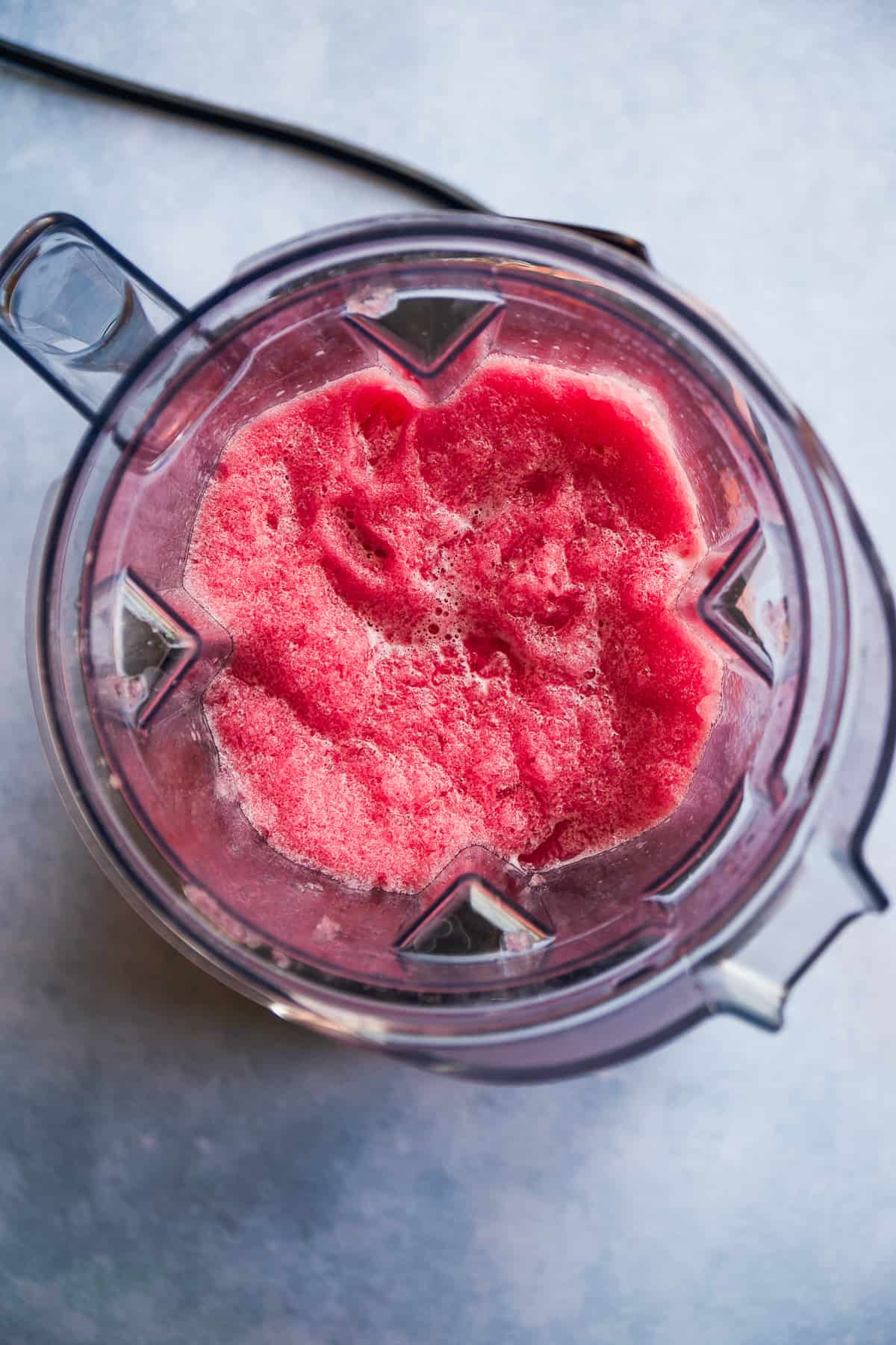 Frozen pomegranate mocktail margarita blended in a blender.