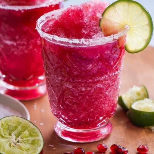 Glass with a frozen pink margarita mocktail.