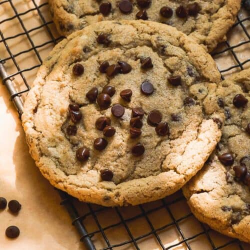 Oat flour chocolate chip cookies scattered on a wire rack.