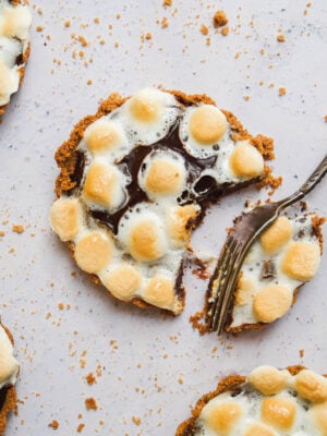 Mini s'mores pie with a fork taking a bite out of one.