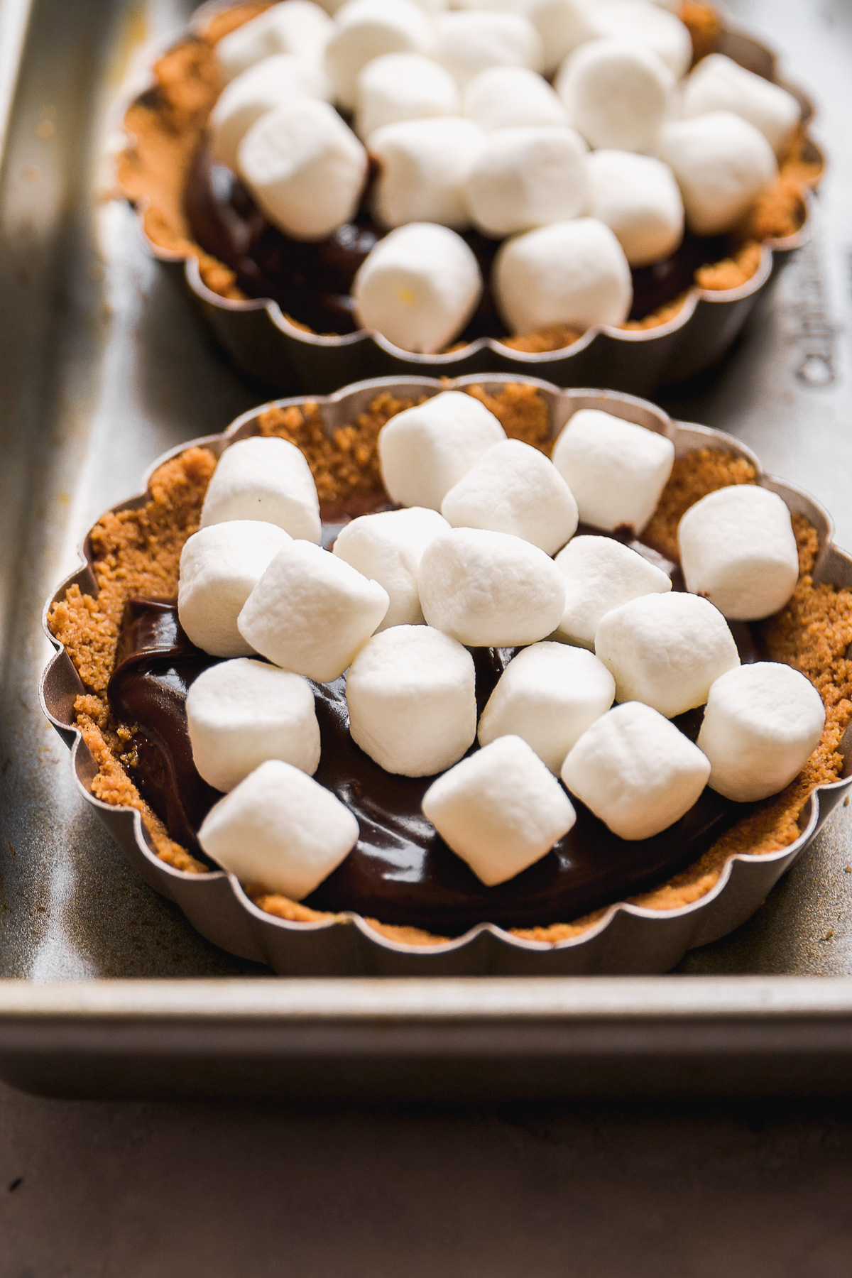 Mini s'mores pies about to be baked in the oven.