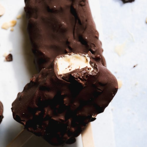 Chocolate crunch frozen yogurt bars with a bite taken out of one.