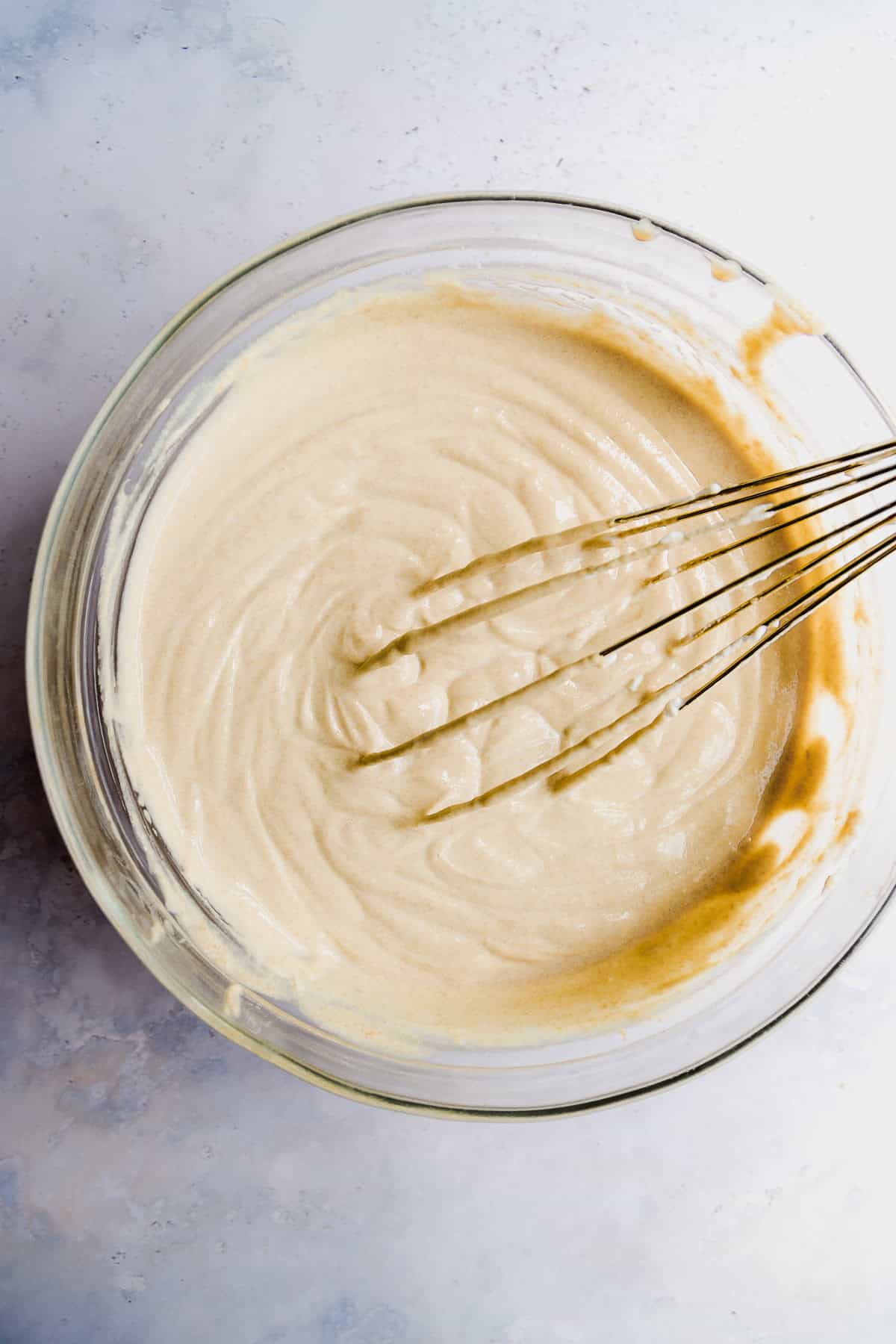 Overhead view of a large mixing bowl with yogurt.