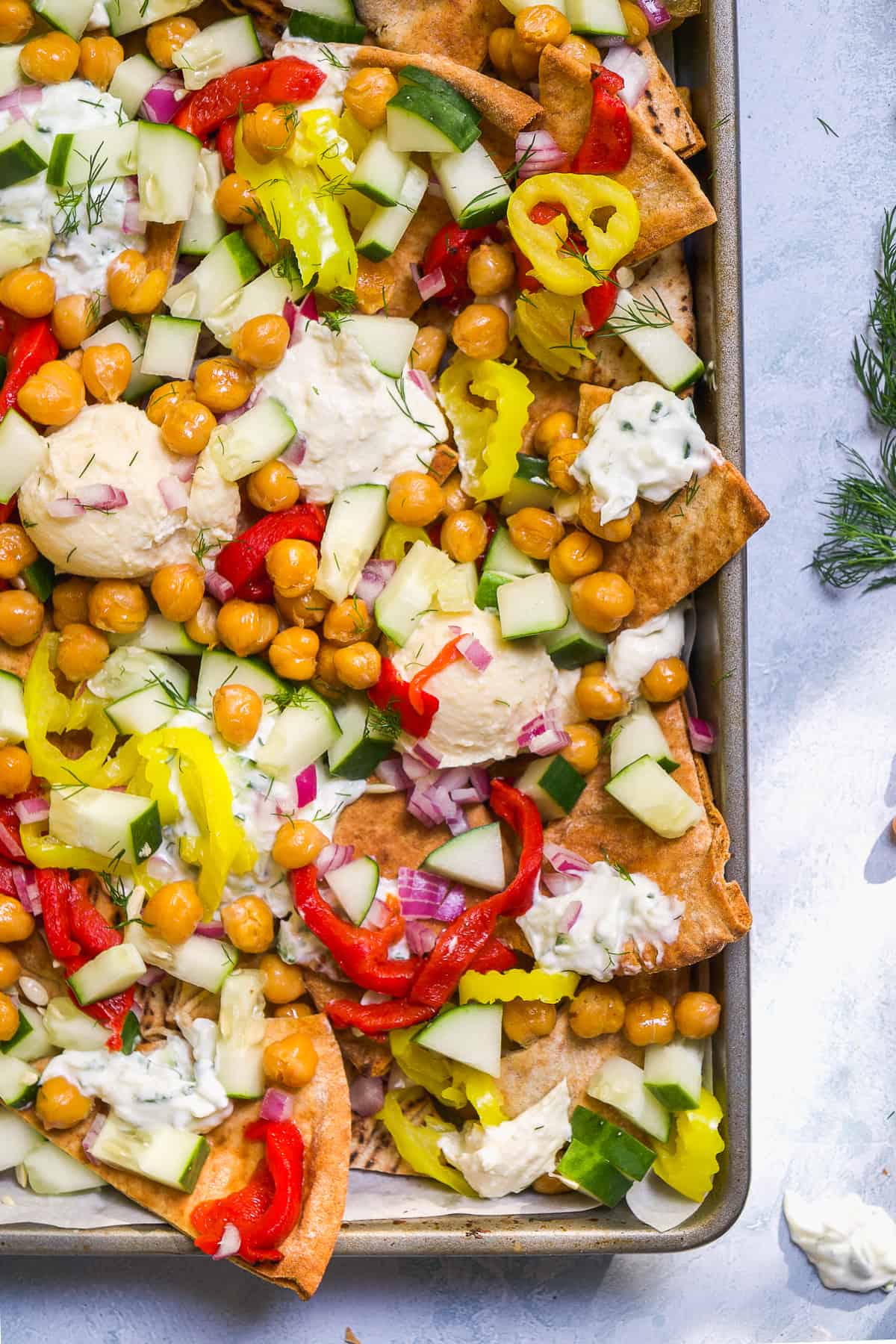 Greek nachos with pita chips and lots of toppings.