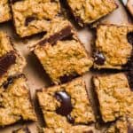 Oatmeal fudge bars scattered on brown parchment paper.