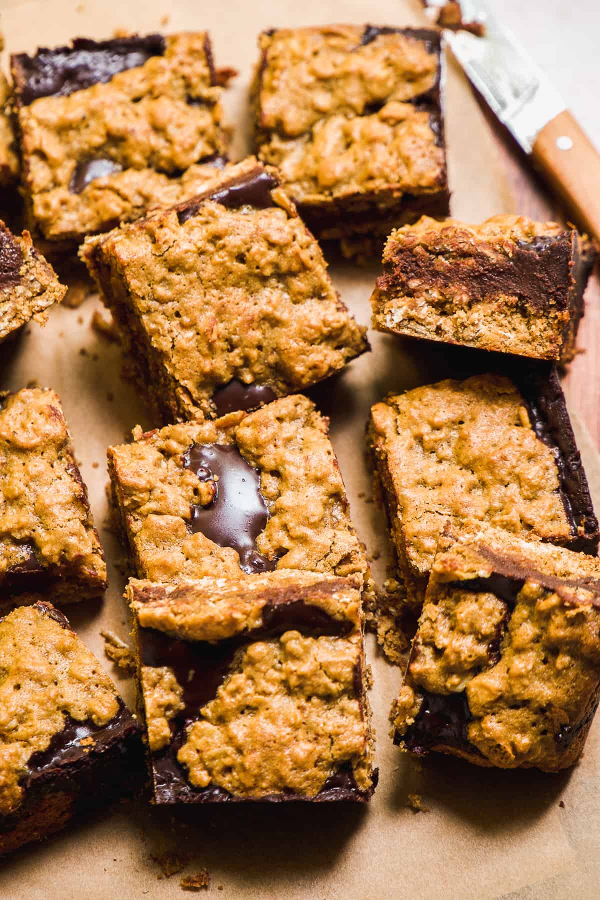 Oatmeal fudge bars piled up on a wooden platter.