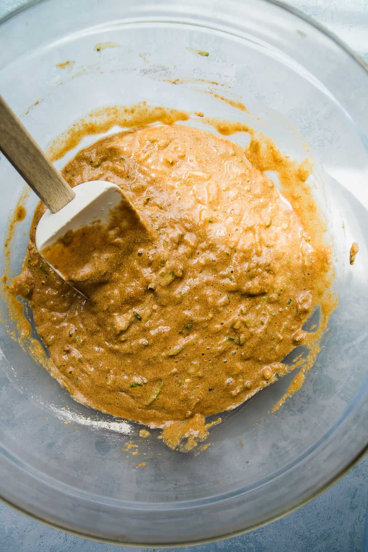 Zucchini muffin batter mixed in a large bowl.