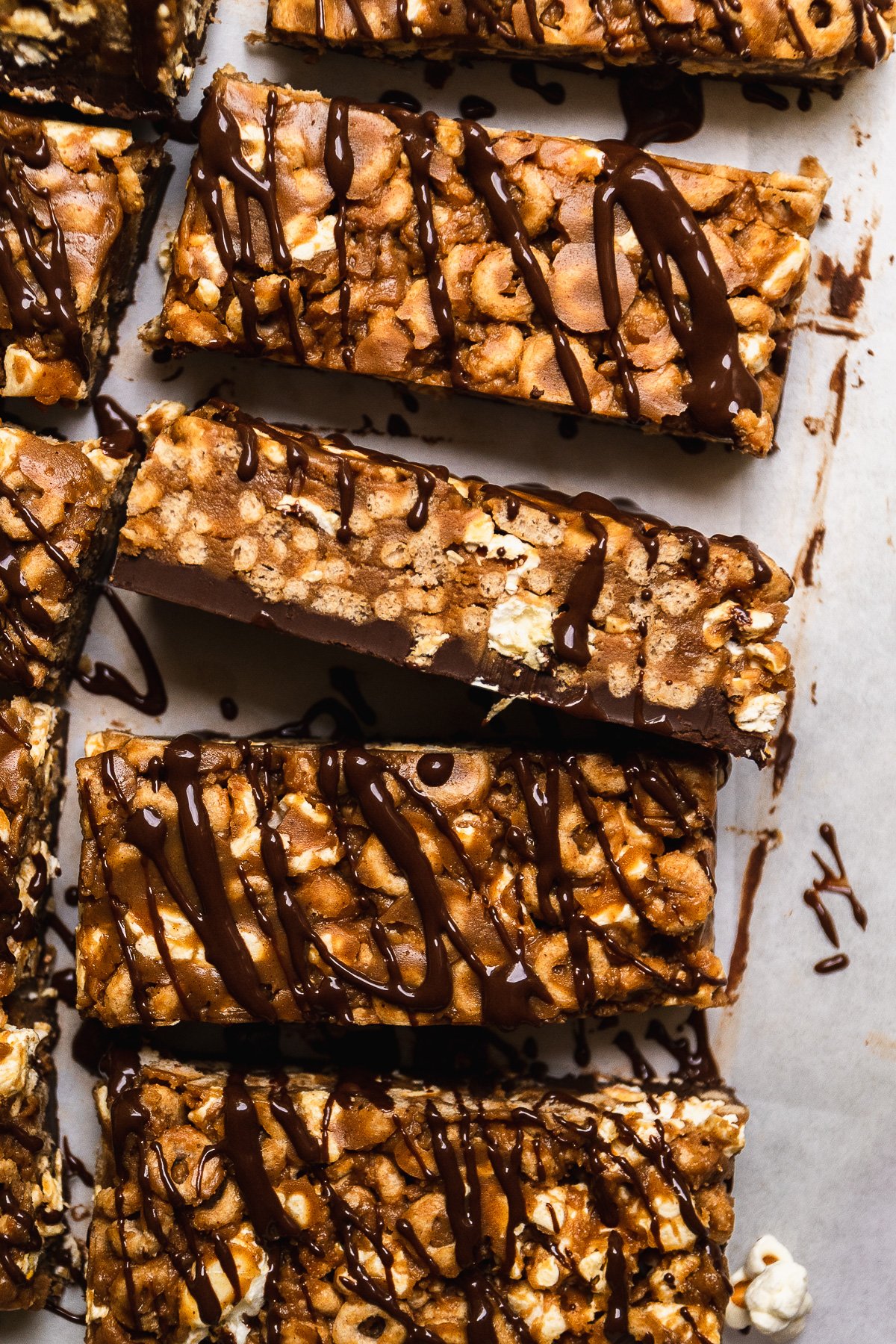 Peanut butter cheerio bars with chocolate drizzled on top.