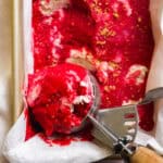 Overhead view of a container of raspberry sherbet.