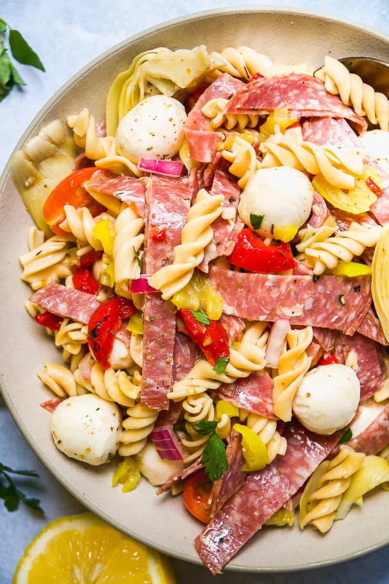 Plate with Italian pasta salad with mozzarella and salami.
