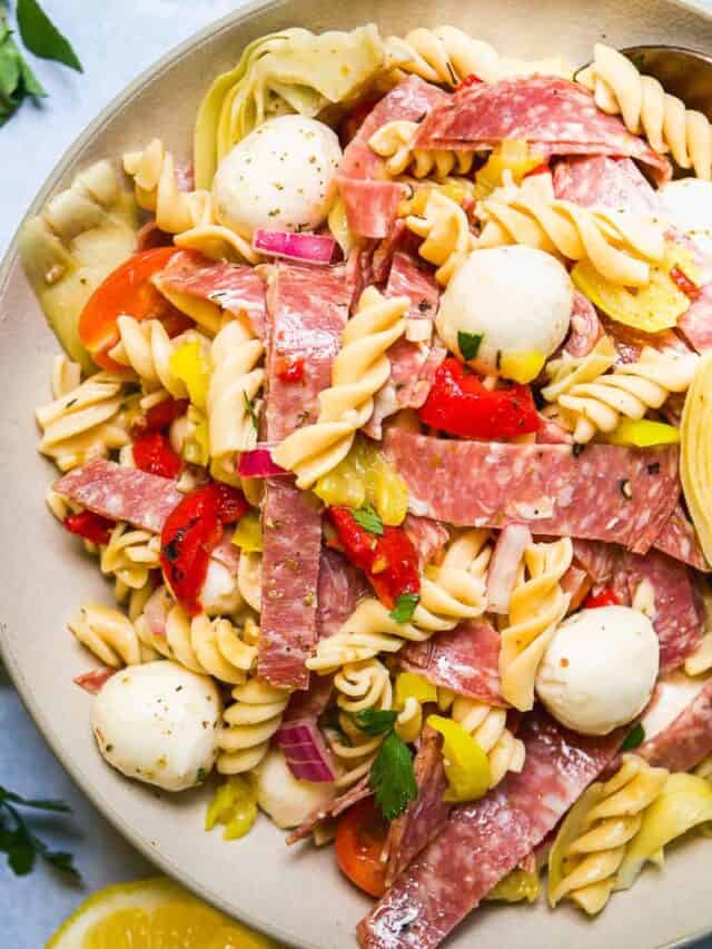 Plate with Italian pasta salad with mozzarella and salami.
