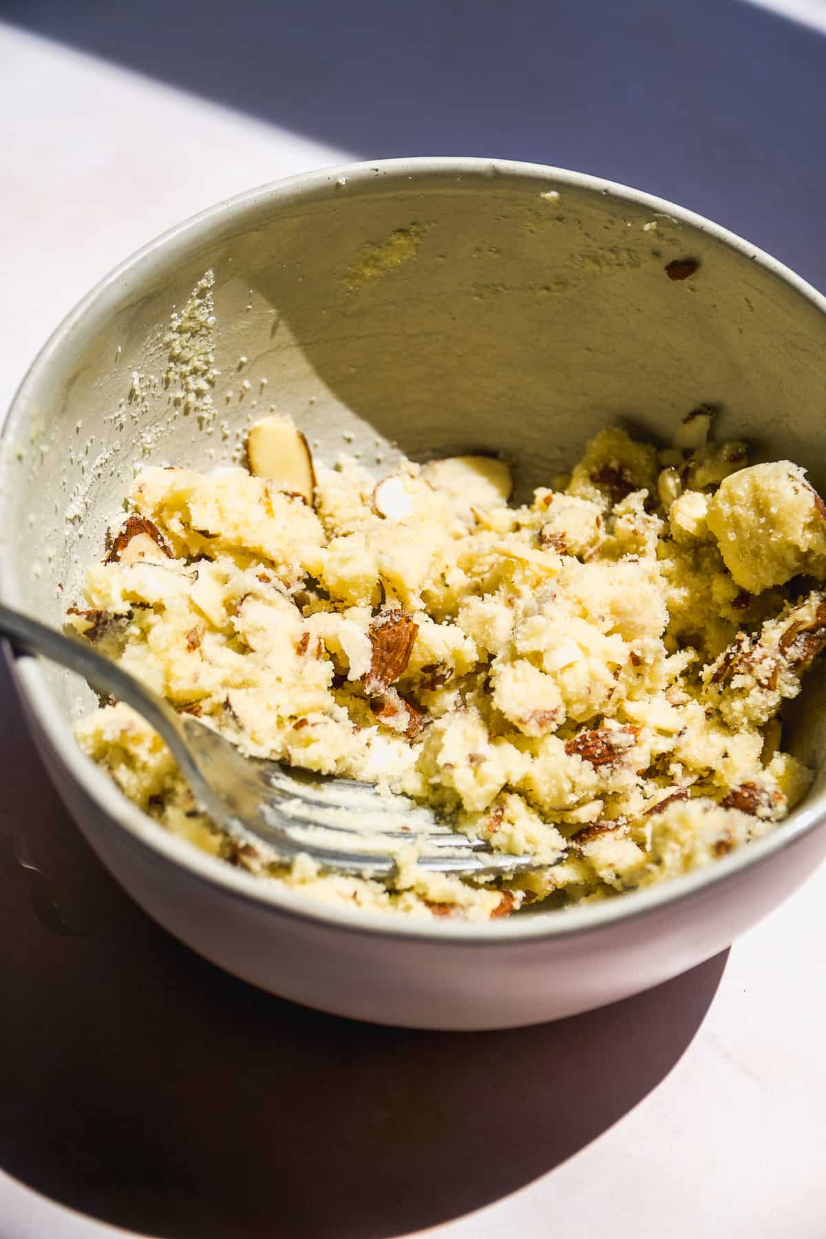 Almond streusel in a bowl with a fork.