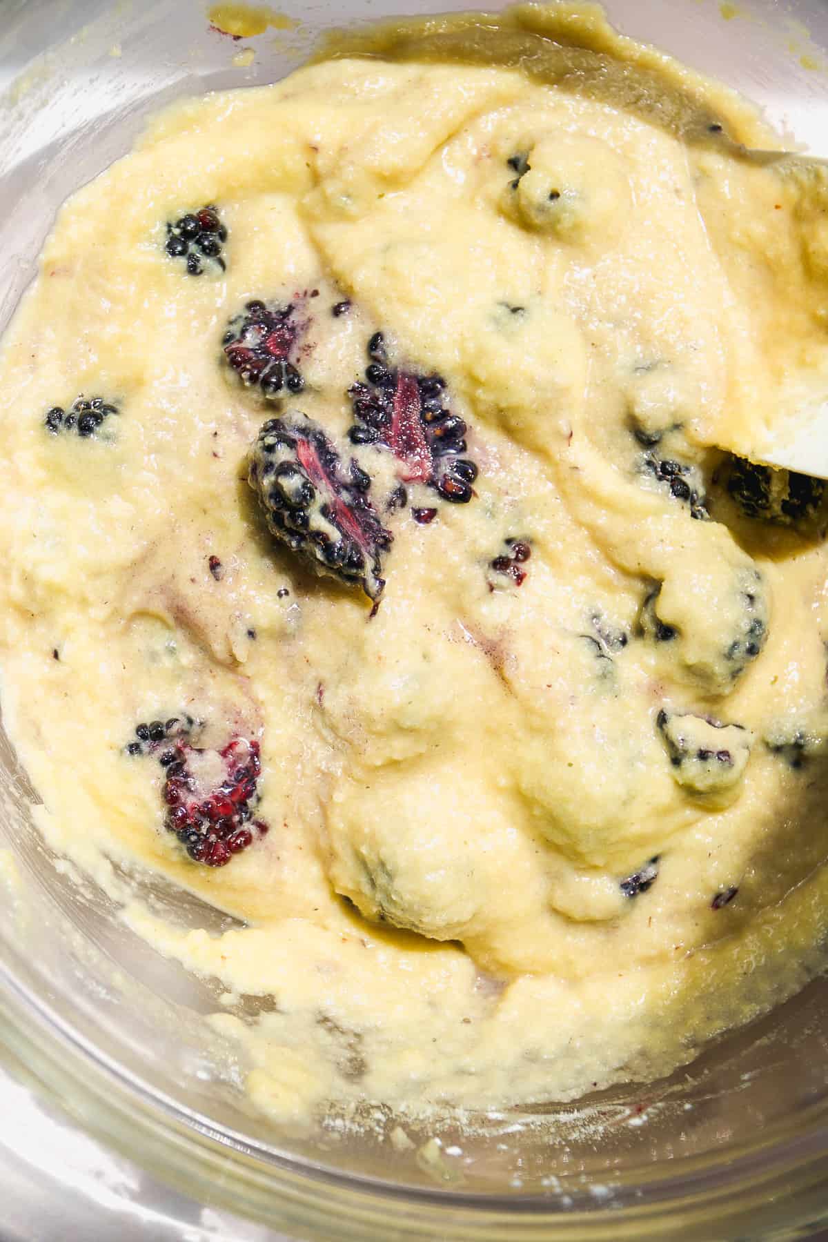 Muffin batter with blackberries mixed in.