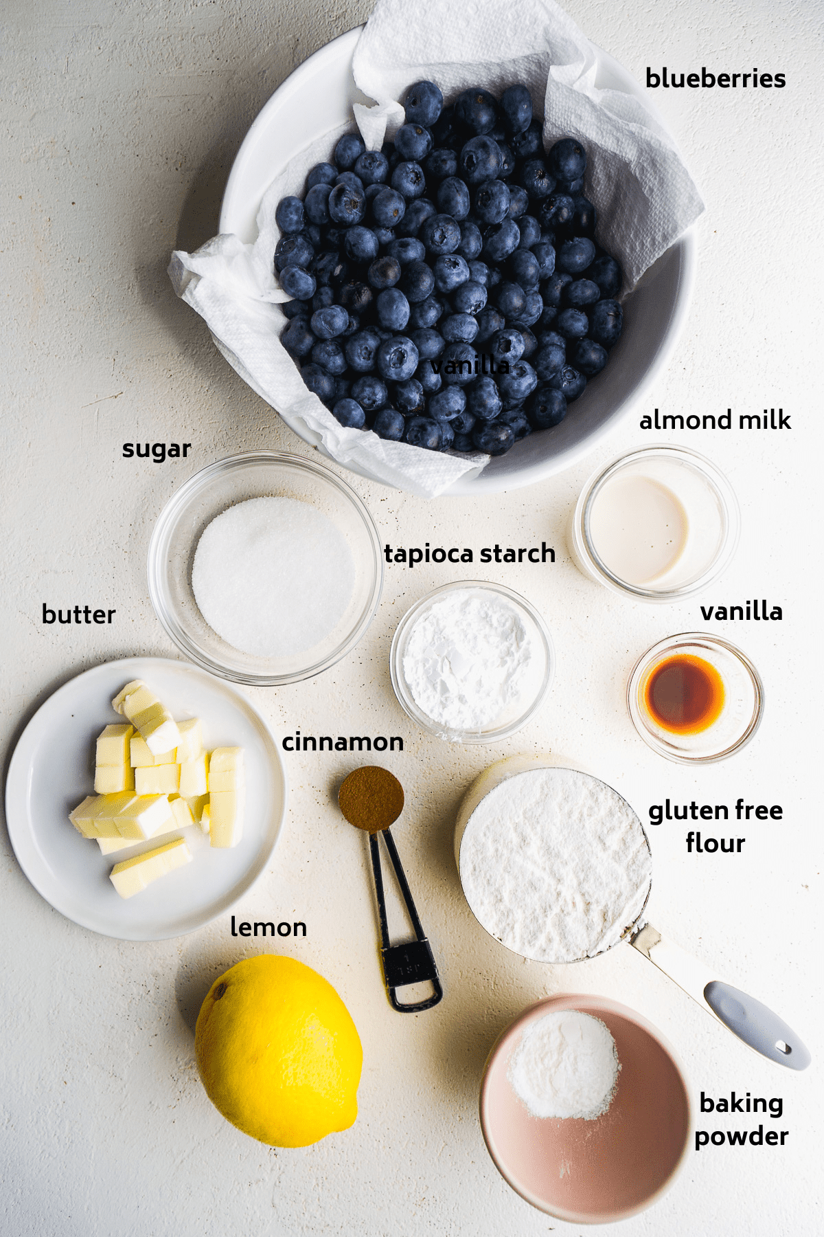 Gluten free blueberry cobbler ingredients on a white surface.
