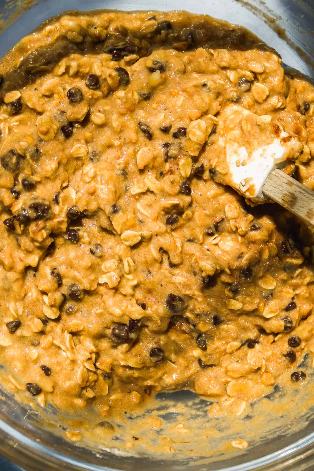 Overhead view of a mixing bowl with peanut butter banana oatmeal cookie batter.
