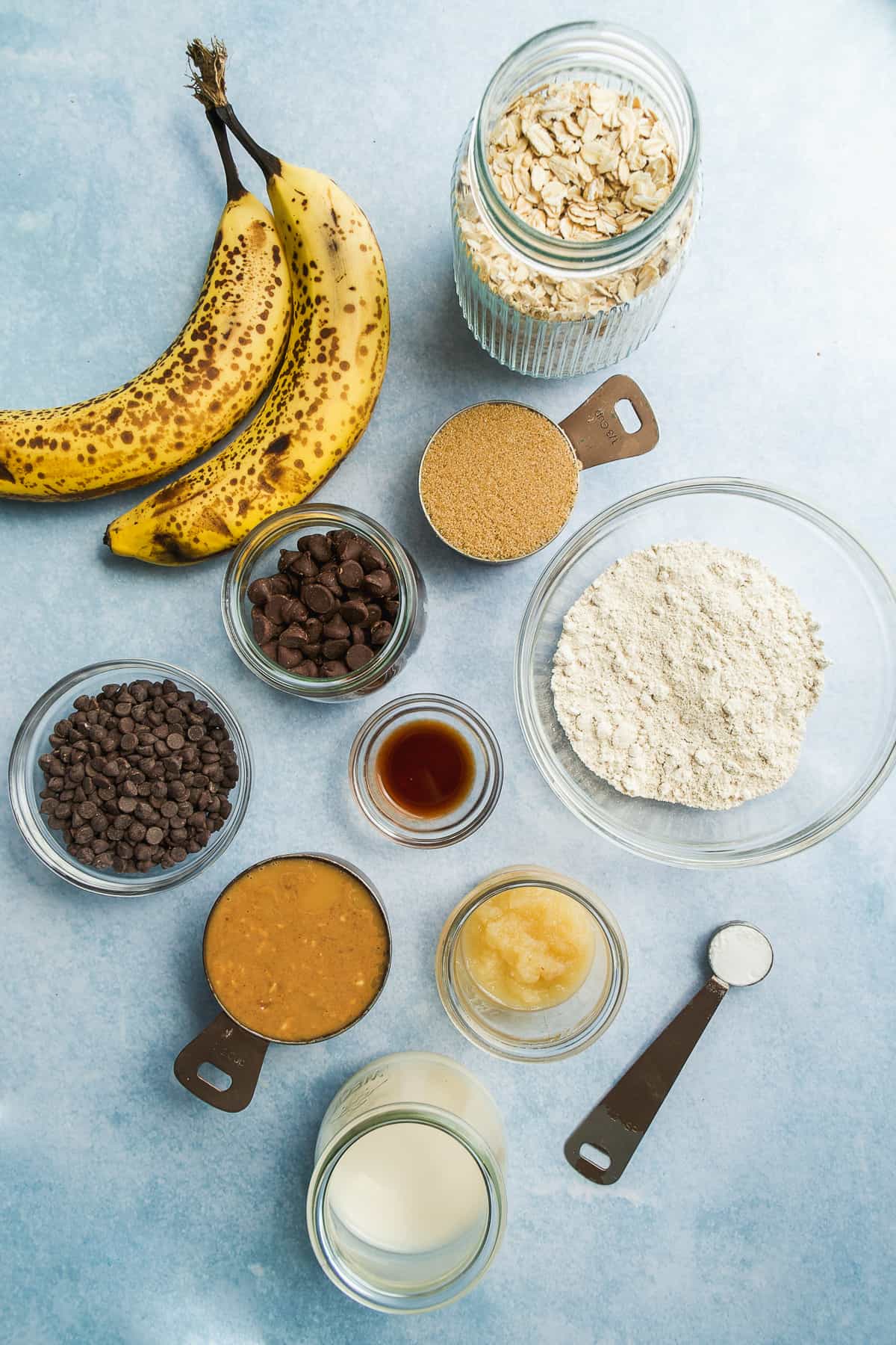 Image of peanut butter banana oatmeal cookie ingredients on a blue surface.