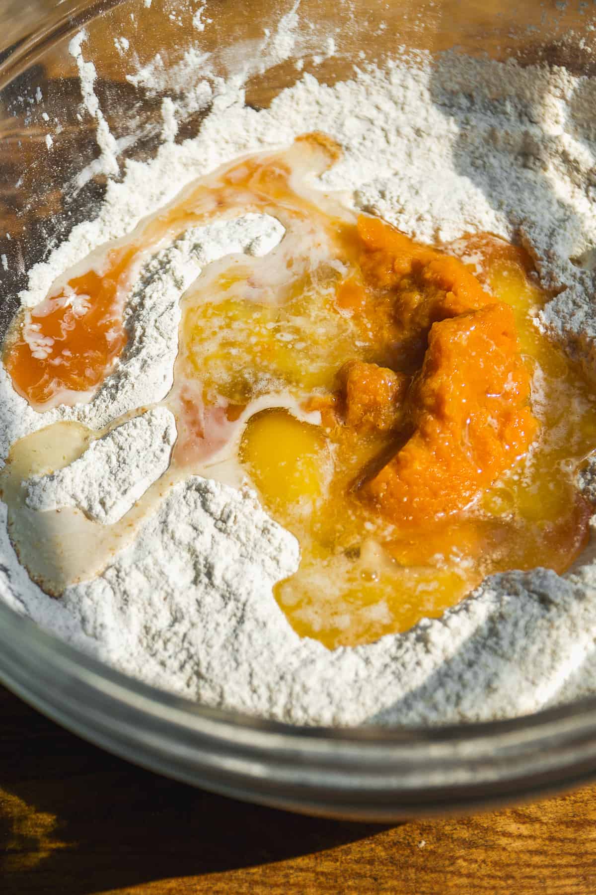 Pumpkin bagel ingredients in a glass bowl about to be mixed.