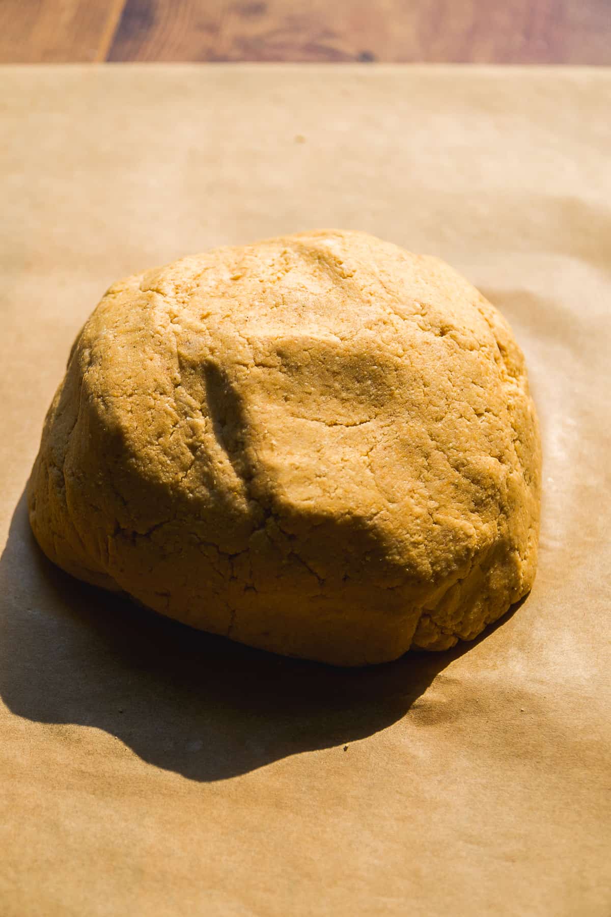 Pumpkin bagel dough on parchment paper.