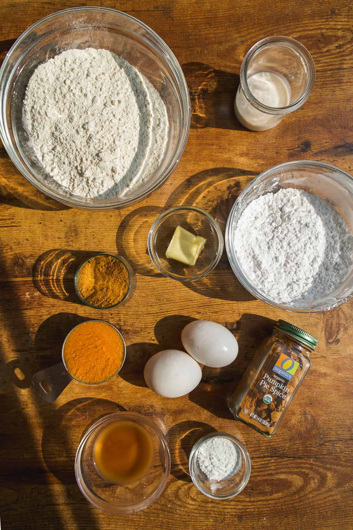 Pumpkin bagel ingredients on a wooden surface.