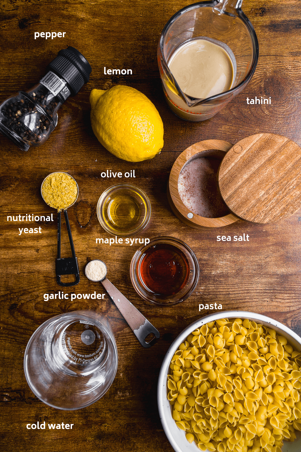 Tahini pasta ingredients on a wooden surface.